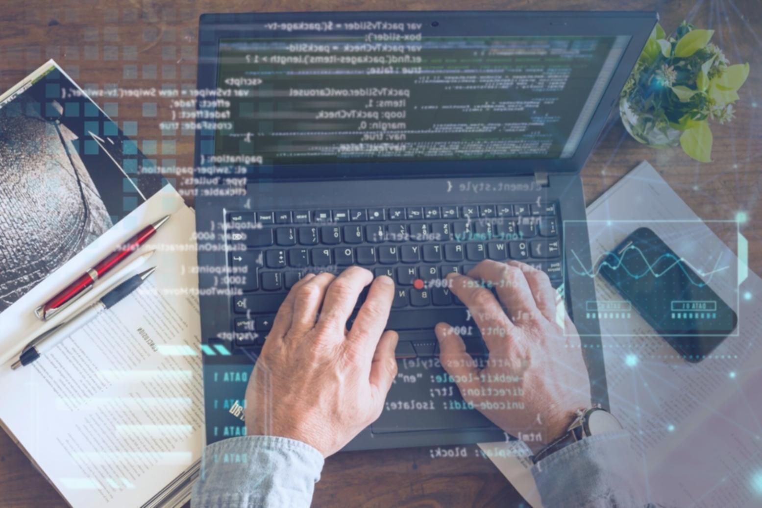 Professional workspace showing custom software development and system automation tools